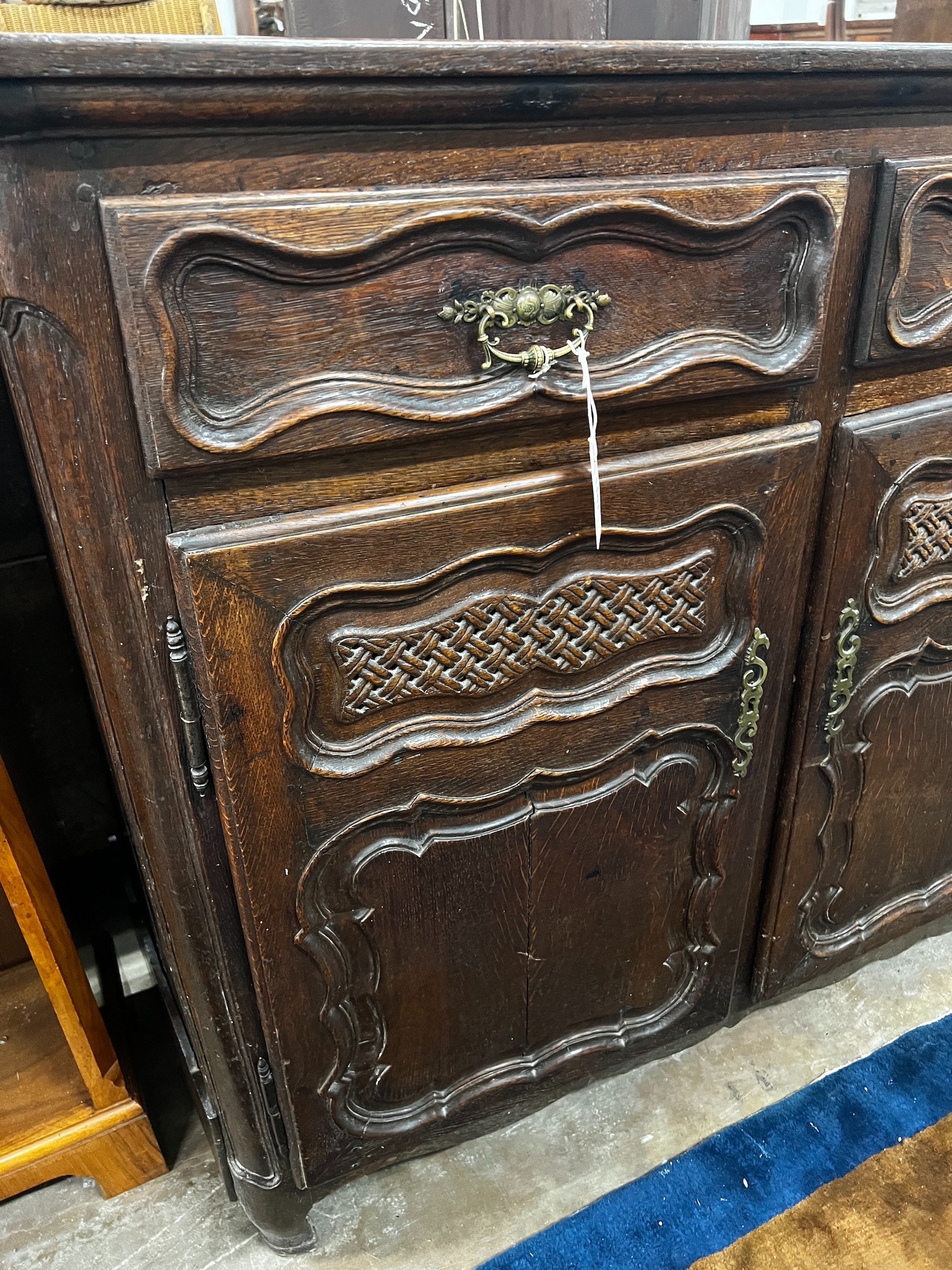 An 18th century French Provincial oak buffet, lacking two feet, width 171cm depth 48cm height 110cm